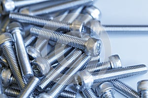 Set of screws close up. Macro photo of screws on a white background. Macro photo chromed screws, screw background, steel screw,