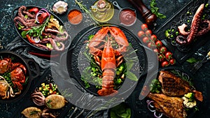 Set of seafood dishes. Fish, squid, octopus on a black stone background. Top view.