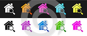 Set Search house icon isolated on black and white background. Real estate symbol of a house under magnifying glass