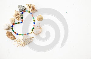 Set of seashells, pearls and stones in form heart