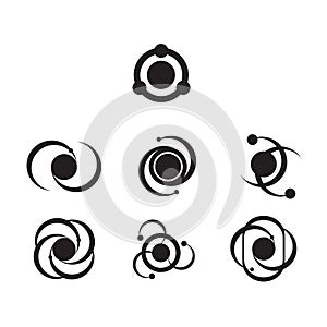 Set of seven simplified atom icons in black and white