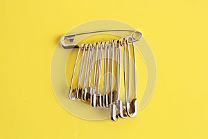 Set of sewing pins on a yellow surface