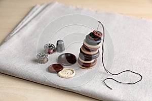 Set of sewing supplies and accessories with fabric on wooden table