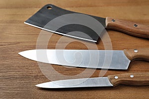 Set of sharp kitchen knives on table