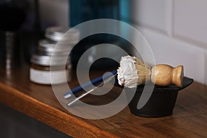 Set of shaving equipment and men's cosmetic products on wooden table, barbershop. shave concept with a straight razor