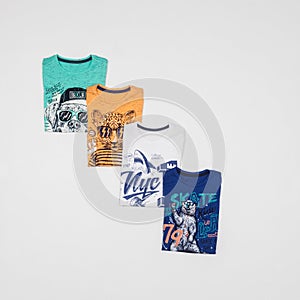 Set of shirts in different colors and colorful prints for children