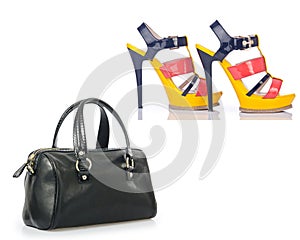 The set of shoes and bags isolated on white