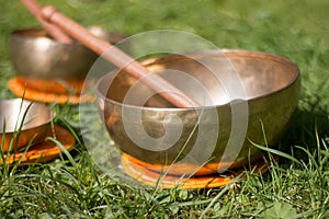 Set of singing bowls in the own garden, zen outdoors photo