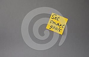 Set smart goals symbol. Concept words Set smart goals on orange steaky note. Beautiful grey background. Business and Set smart