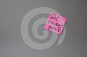 Set smart goals symbol. Concept words Set smart goals on pink steaky note. Beautiful grey background. Business and Set smart goals