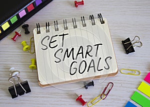 Set smart goals symbol. Concept words Set smart goals on white notebook. Beautiful wooden background. Business and Set smart goals