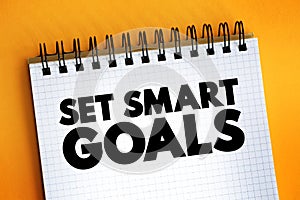 Set Smart Goals text on notepad, concept background