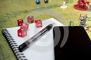 Set of smartphone, notebook and mechanical pencil to play dices on the role play dungeons and dragons