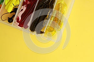 Set of soft fishing lures isolated on yellow background