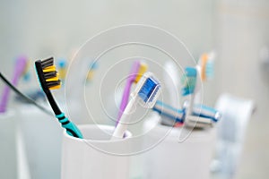 a set of some colorful toothbrushes razor blades on the shelf in bathroom, personal accessories