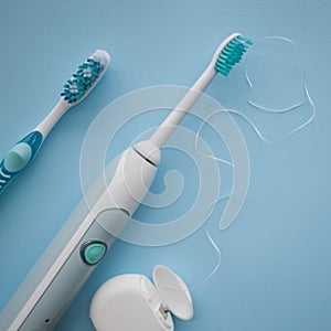 A set of sonic toothbrush, dental floss and classic toothbrush