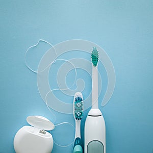 A set of sonic toothbrush, dental floss and classic toothbrush