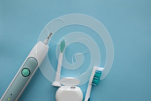 A set of sonic toothbrush, dental floss and classic toothbrush