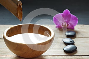 Set for spa procedures, stones for hot massage and flavored water, recruited from a bamboo stem into a bowl
