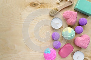 Set of spa products. Soap, bath bombs and candles on wooden background, space for text