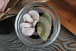 Set of spices in glass bowl - garlic, pepper, Bay leaf