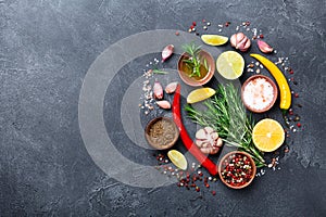 Set of spices and herbs on black stone table top view. Ingredients for cooking. Food background.
