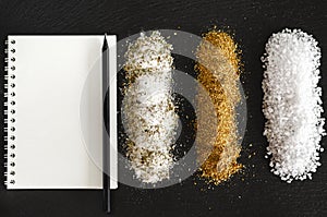 Set of spices and salt for cooking on black background