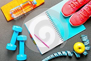 Set of sports accessories for fitness concept with exercise equipment on gray background