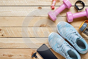 Set of sports accessories for fitness healthy and weight loss dieting concept with exercise equipment on grunge wooden background