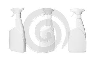 Set with spray bottles of cleaning product on white background