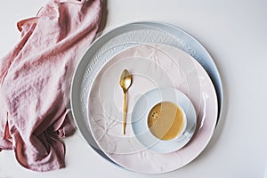 set of spring dishware on white background. Ceramic plates and cup of coffee