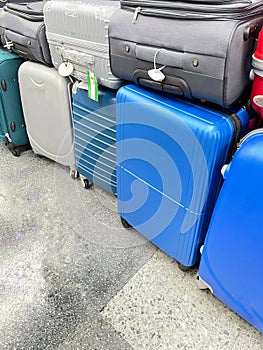 Set of stacked carry-on suitcases in different colors. Travel and vacation concept