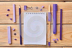 Set of stationery items on a wooden background.