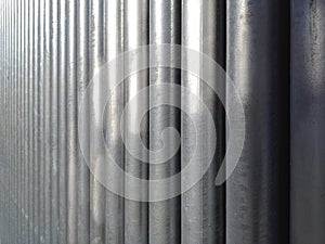 Texture of round chrome steel pipe sort in vertical, abstract background. Architectural detail. Set Steel or Aluminum pipes