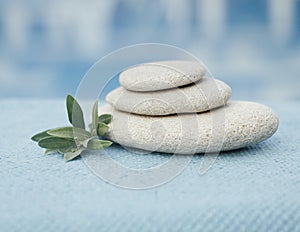 Set of stones and towel for spa therapy. Blue shades. Massage room. Aroma and acupuncture therapy.