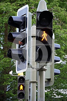 A set of stoplight or traffic lights with an orange light on in a a residential district in Switzerland