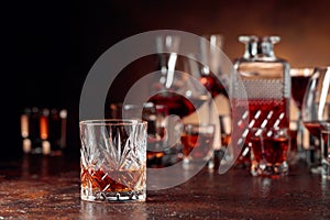 Set of strong alcoholic beverages in glasses on a brown background