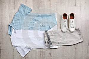 Set of stylish clothes and accessories on floor, flat lay