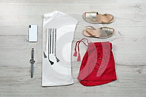 Set of stylish clothes and accessories on wooden floor