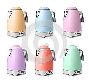 Set with stylish electrical kettles on white background