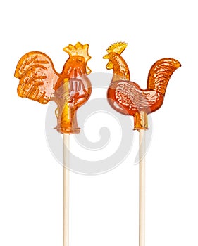 Set of sugar lollipop made in the shape of cockerels on a wooden stick