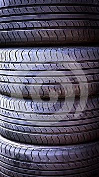 Set of summer car tires isolated. Tire stack background. Car tyre protector close up. Black rubber tire. New car tires. Close up