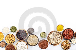 Set of superfoods, legumes, cereals, nuts, seeds in bowls on white background. Superfood as chia, spirulina, beans, goji berries,