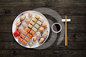 Set of sushi maki and rolls at wood background