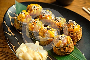 A set of sushi rolls with salmon, caviar, avocado and black sesame