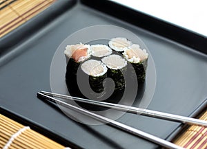 Set of sushi served on a plate with chopsticks