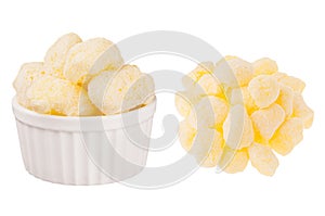 Set of sweet yellow corn sticks with powdered sugar as heap and in ceramics bowl isolated on white background.