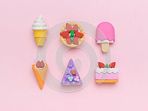 A set of sweets made of cake and ice cream on a pink background