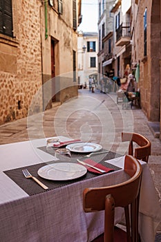 Set table of restaurant on the street in Alcudia, Majorca