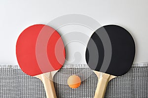 Set of table tennis paddles net and ball on white